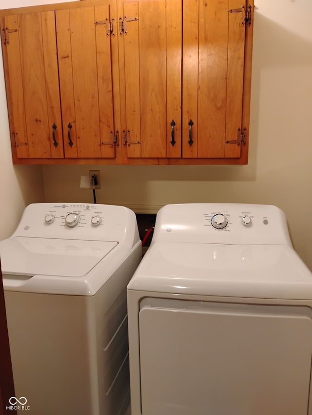 721 Maplewood Ave, Anderson, IN 46012 - laundry area featuring separate washer and dryer and cabinet space