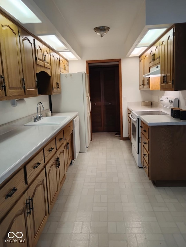 721 Maplewood Ave, Anderson, IN 46012 - kitchen with white appliances, under cabinet range hood, light countertops, and light flooring