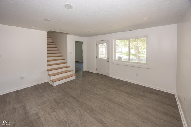 12003 Broadway St, Indianapolis, IN 46236 - unfurnished living room featuring stairway, dark wood-type flooring, and a textured ceiling