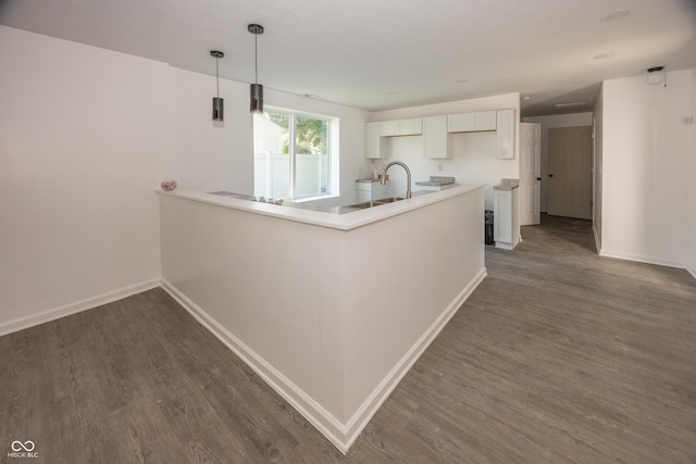 12003 Broadway St, Indianapolis, IN 46236 - kitchen with dark wood finished floors, white cabinets, decorative light fixtures, and a peninsula