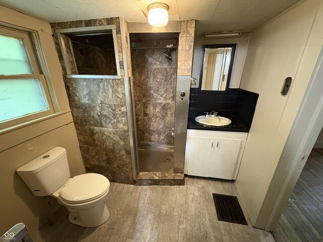 807 N Elm St, Muncie, IN 47305 - bathroom with vanity, a stall shower, and wood finished floors