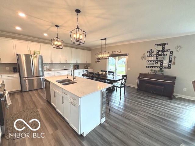 520 Ferndale Ln, Danville, IN 46122 - kitchen featuring stainless steel appliances, crown molding, white cabinetry, a chandelier, and recessed lighting