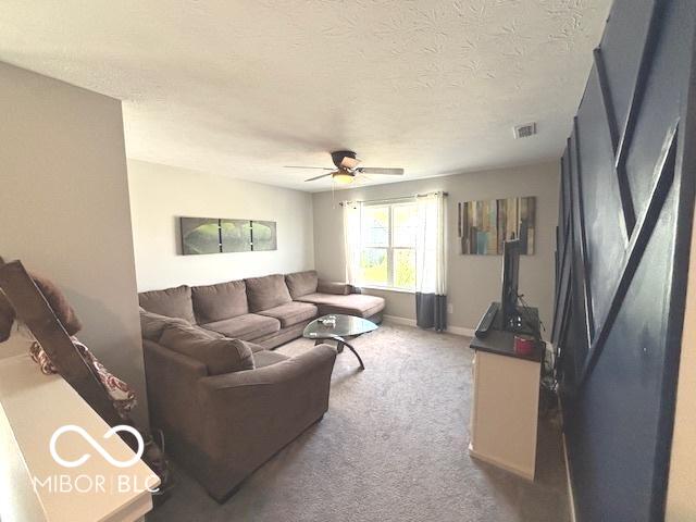 520 Ferndale Ln, Danville, IN 46122 - living area featuring a ceiling fan, carpet flooring, and a textured ceiling