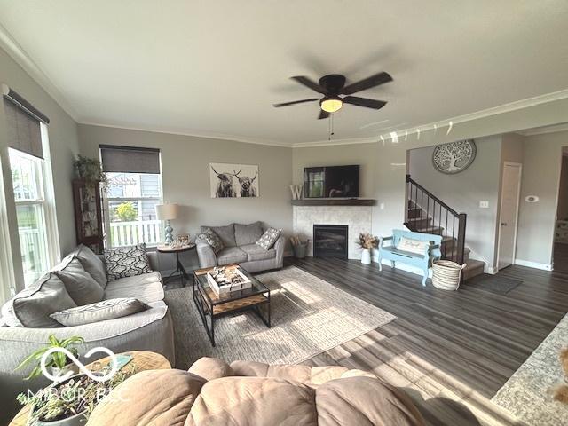 520 Ferndale Ln, Danville, IN 46122 - living area with stairs, wood finished floors, a fireplace, a ceiling fan, and crown molding