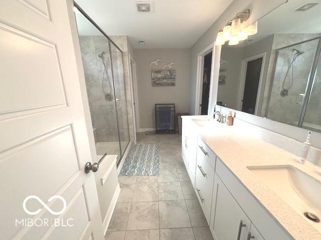 520 Ferndale Ln, Danville, IN 46122 - bathroom with double vanity, a shower stall, and tile patterned floors