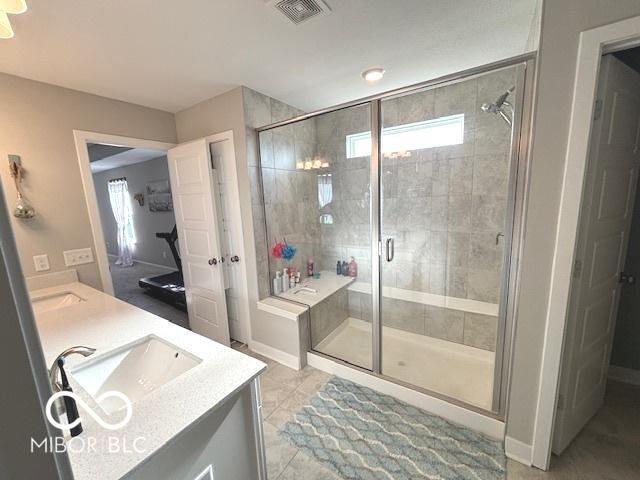 520 Ferndale Ln, Danville, IN 46122 - full bathroom featuring plenty of natural light, double vanity, a shower stall, and tile patterned floors