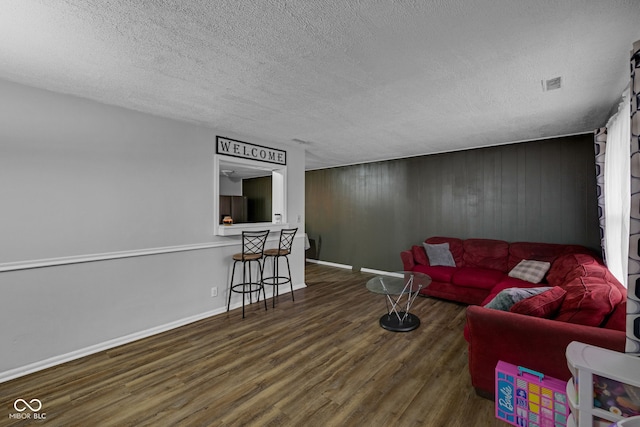 3509 N Wittfield St, Indianapolis, IN 46235 - living room with wood finished floors, a textured ceiling, and wood walls