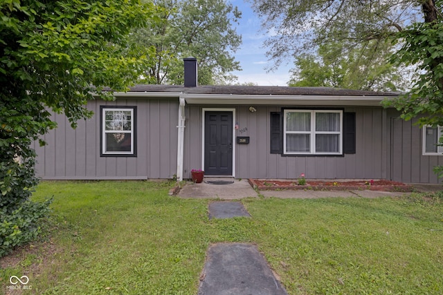 3509 N Wittfield St, Indianapolis, IN 46235 - ranch-style house with a chimney, a front lawn, and board and batten siding