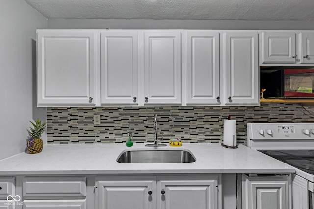 3509 N Wittfield St, Indianapolis, IN 46235 - kitchen with black microwave, white range with electric stovetop, white cabinets, and decorative backsplash