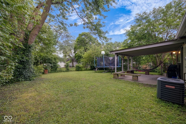 3509 N Wittfield St, Indianapolis, IN 46235 - view of green lawn with a trampoline and a patio