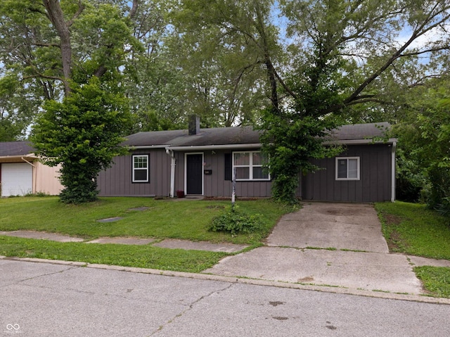 3509 N Wittfield St, Indianapolis, IN 46235 - ranch-style home featuring board and batten siding, a front lawn, driveway, and a chimney