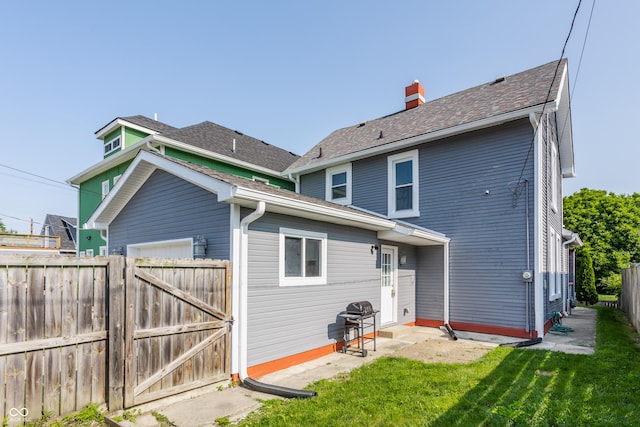 525 Orange St, Indianapolis, IN 46203 - rear view of property featuring a gate, a chimney, and a patio