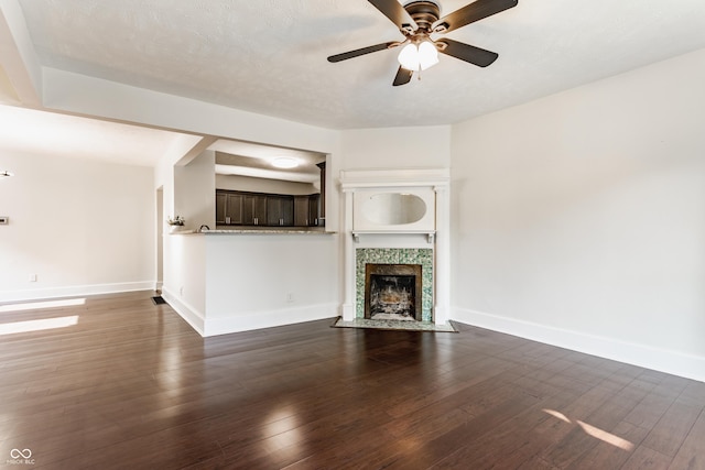 525 Orange St, Indianapolis, IN 46203 - unfurnished living room featuring a ceiling fan, dark wood finished floors, and a tiled fireplace