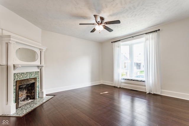 525 Orange St, Indianapolis, IN 46203 - unfurnished living room featuring a ceiling fan, a tile fireplace, a textured ceiling, and dark wood-type flooring