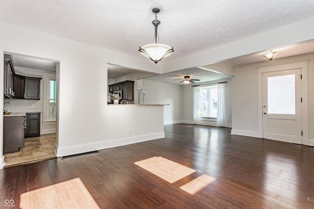 525 Orange St, Indianapolis, IN 46203 - unfurnished living room featuring dark wood finished floors and ceiling fan