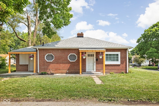 4502 Evanston Ave, Indianapolis, IN 46205 - bungalow-style house featuring a chimney, brick siding, a front lawn, and roof with shingles