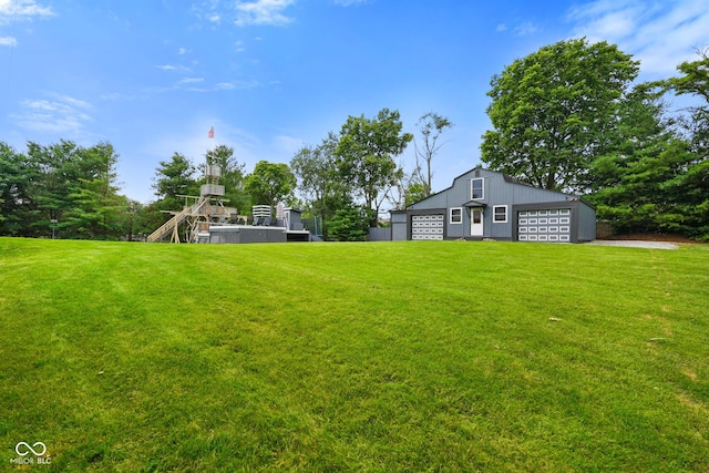 12196 N Beth Ann Dr, Camby, IN 46113 - view of green lawn featuring an outbuilding, a detached garage, and stairs