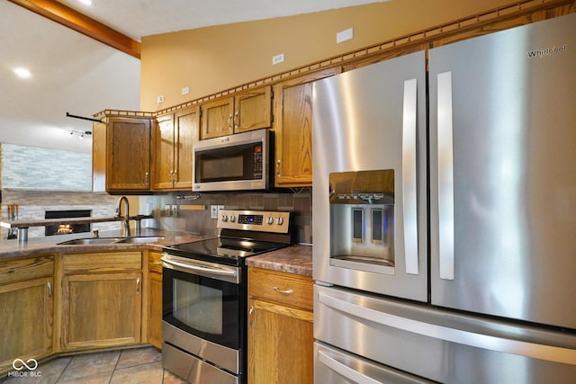 12196 N Beth Ann Dr, Camby, IN 46113 - kitchen with stainless steel appliances, backsplash, brown cabinets, light tile patterned floors, and recessed lighting