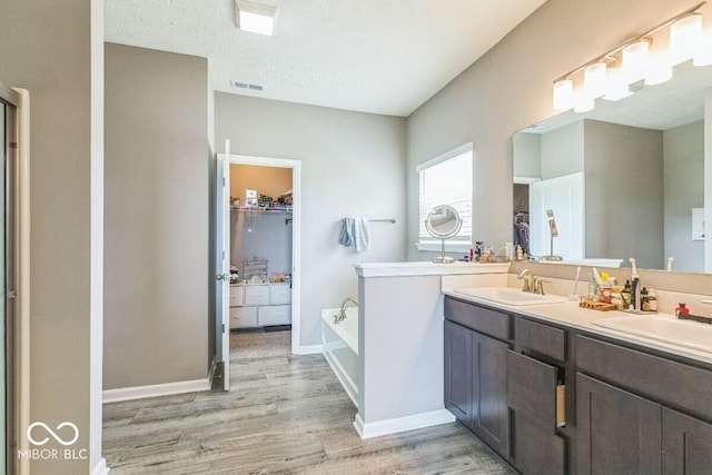 1758 Pelham Dr, Greenwood, IN 46143 - full bath with a spacious closet, wood finished floors, double vanity, and a garden tub