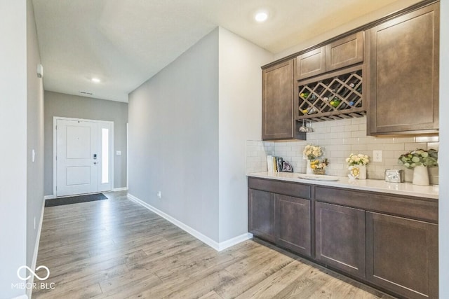 1758 Pelham Dr, Greenwood, IN 46143 - bar with light wood finished floors, backsplash, and recessed lighting