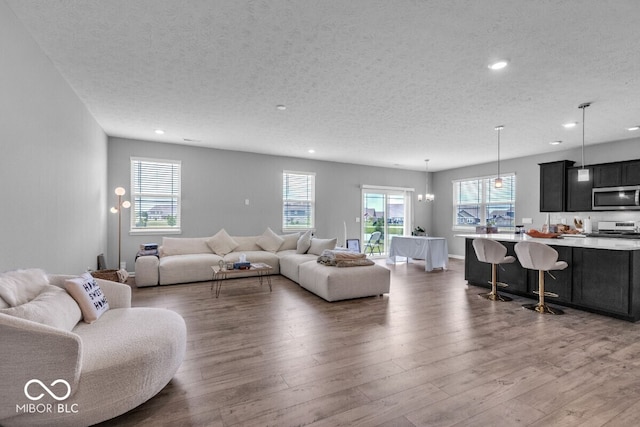 1758 Pelham Dr, Greenwood, IN 46143 - living room featuring a textured ceiling, wood finished floors, and recessed lighting