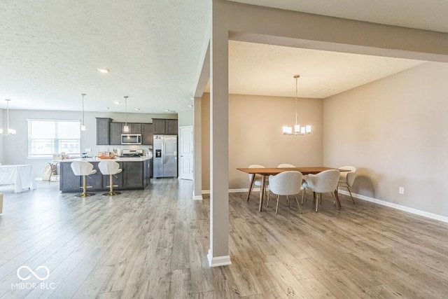 1758 Pelham Dr, Greenwood, IN 46143 - dining area with a chandelier and light wood-style flooring