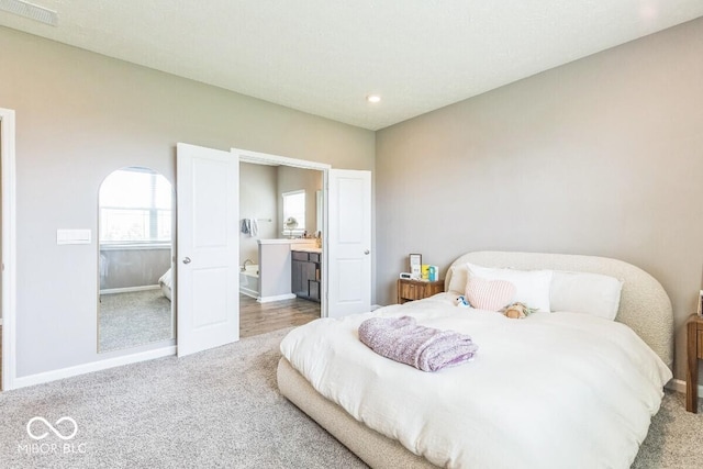 1758 Pelham Dr, Greenwood, IN 46143 - carpeted bedroom featuring ensuite bath and recessed lighting