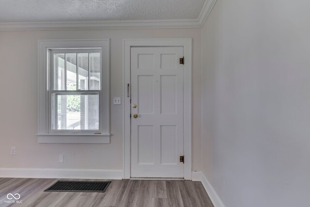 2245 N Ritter Ave, Indianapolis, IN 46218 - entryway with wood finished floors, crown molding, and a textured ceiling