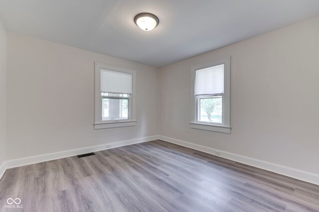 2245 N Ritter Ave, Indianapolis, IN 46218 - empty room with plenty of natural light and wood finished floors