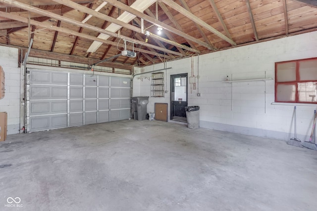 2245 N Ritter Ave, Indianapolis, IN 46218 - garage with a garage door opener and concrete block wall