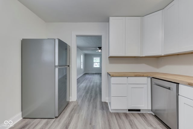2245 N Ritter Ave, Indianapolis, IN 46218 - kitchen featuring appliances with stainless steel finishes, wood counters, light wood-type flooring, and white cabinetry