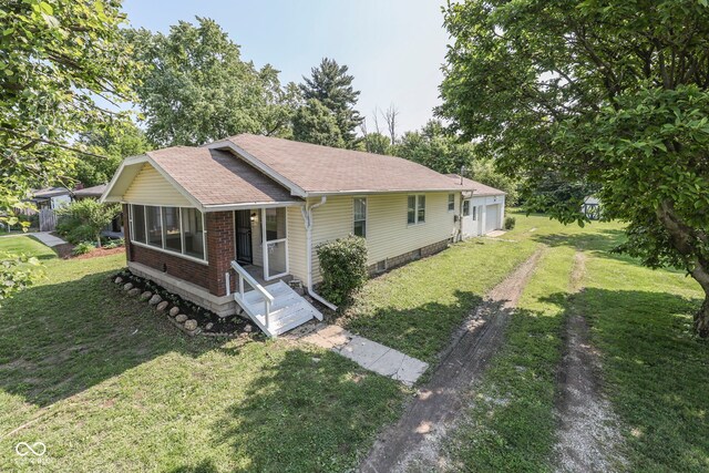 2245 N Ritter Ave, Indianapolis, IN 46218 - ranch-style home with a front yard and a shingled roof