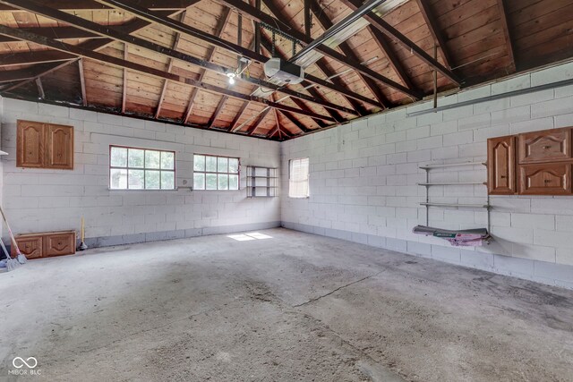 2245 N Ritter Ave, Indianapolis, IN 46218 - garage featuring a garage door opener and concrete block wall