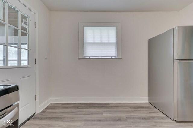 2245 N Ritter Ave, Indianapolis, IN 46218 - kitchen with freestanding refrigerator and light wood-style floors