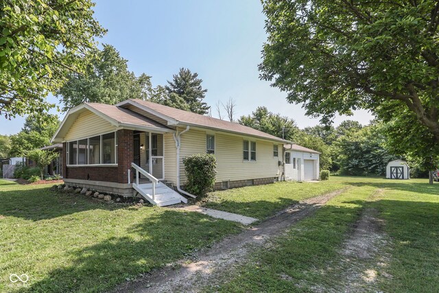 2245 N Ritter Ave, Indianapolis, IN 46218 - single story home featuring a shed, a garage, a front yard, and a shingled roof