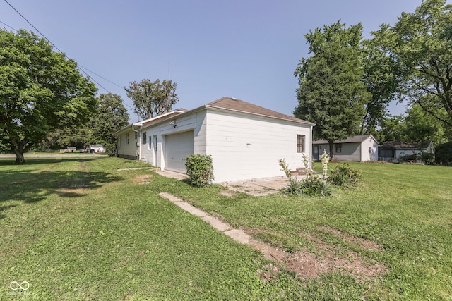 2245 N Ritter Ave, Indianapolis, IN 46218 - view of side of home featuring a lawn and a garage