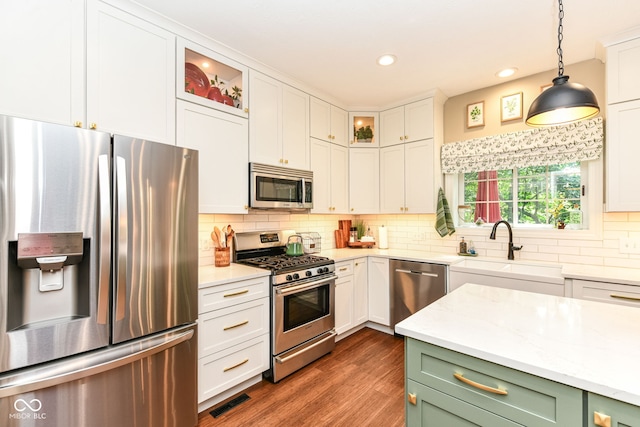 9825 Covington Blvd, Fishers, IN 46037 - kitchen with appliances with stainless steel finishes, white cabinets, decorative backsplash, glass insert cabinets, and recessed lighting