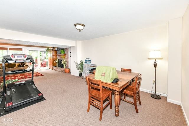 9825 Covington Blvd, Fishers, IN 46037 - dining room with light carpet and a brick fireplace