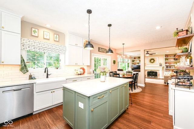 9825 Covington Blvd, Fishers, IN 46037 - kitchen with stainless steel dishwasher, green cabinetry, a ceiling fan, white cabinetry, and decorative backsplash