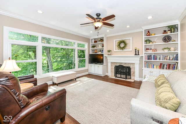 9825 Covington Blvd, Fishers, IN 46037 - living room with wood finished floors, ceiling fan, a high end fireplace, crown molding, and recessed lighting