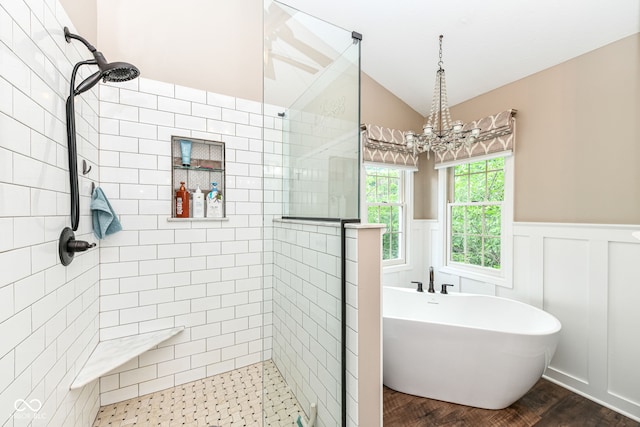 9825 Covington Blvd, Fishers, IN 46037 - bathroom with a stall shower, a soaking tub, vaulted ceiling, wood finished floors, and a wainscoted wall