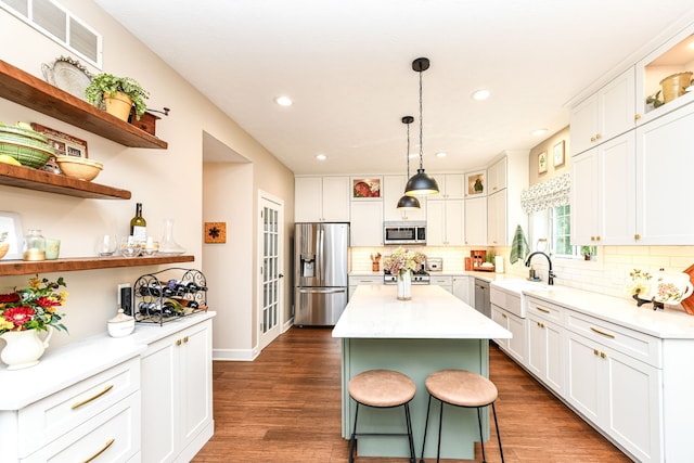 9825 Covington Blvd, Fishers, IN 46037 - kitchen featuring stainless steel appliances, open shelves, white cabinetry, backsplash, and recessed lighting