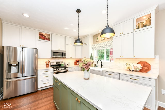 9825 Covington Blvd, Fishers, IN 46037 - kitchen featuring stainless steel appliances, dark wood-style floors, white cabinets, a kitchen island, and recessed lighting