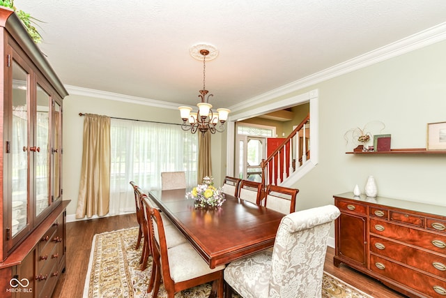 9825 Covington Blvd, Fishers, IN 46037 - dining room featuring a chandelier, crown molding, dark wood finished floors, and stairway