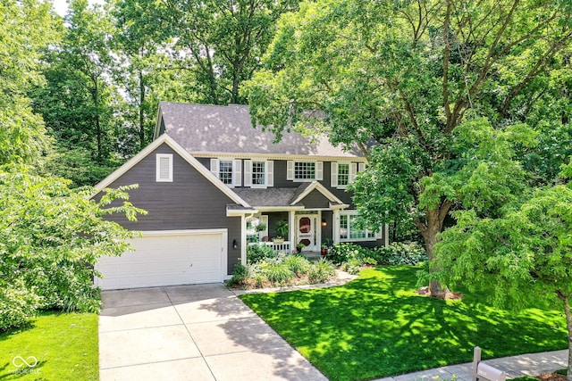 9825 Covington Blvd, Fishers, IN 46037 - view of front of home with driveway, a front yard, roof with shingles, an attached garage, and a porch