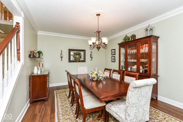 9825 Covington Blvd, Fishers, IN 46037 - dining area with dark wood-style floors, crown molding, a chandelier, and stairway