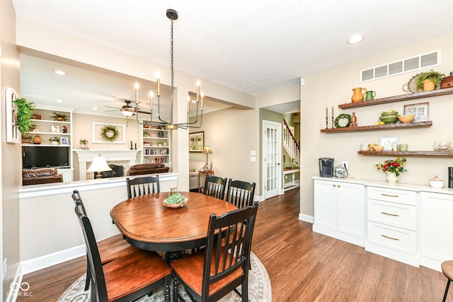 9825 Covington Blvd, Fishers, IN 46037 - dining area featuring ceiling fan, a fireplace, light wood-type flooring, and recessed lighting