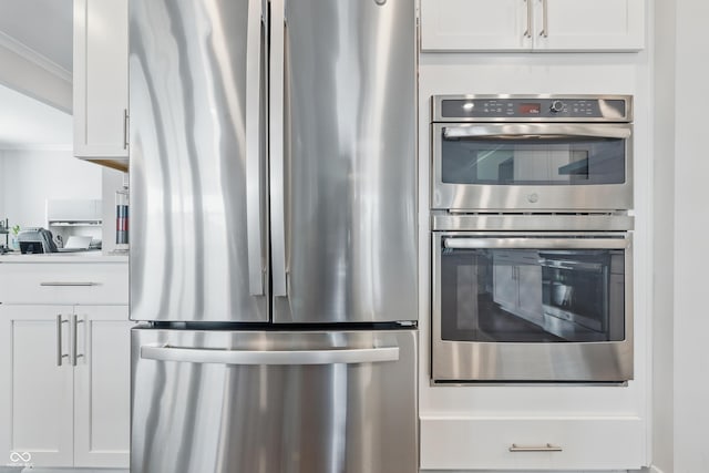 3839 Albert Ln, Bargersville, IN 46106 - kitchen featuring appliances with stainless steel finishes, ornamental molding, and white cabinets