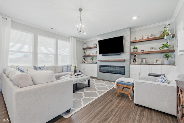 3839 Albert Ln, Bargersville, IN 46106 - living area featuring dark wood-style flooring, crown molding, a large fireplace, a chandelier, and recessed lighting