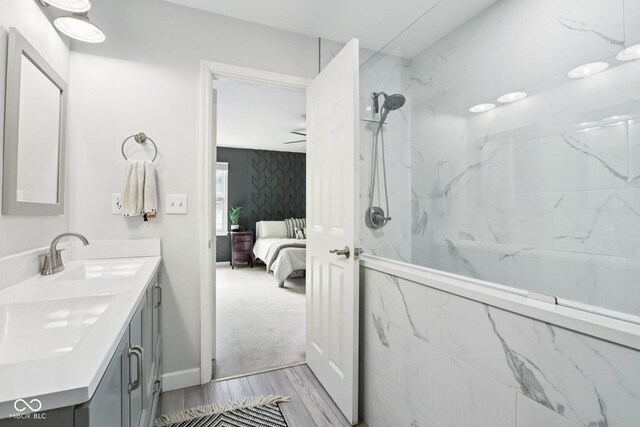 7029 Kingswood Cir, Indianapolis, IN 46256 - ensuite bathroom with double vanity, wood finished floors, and a marble finish shower